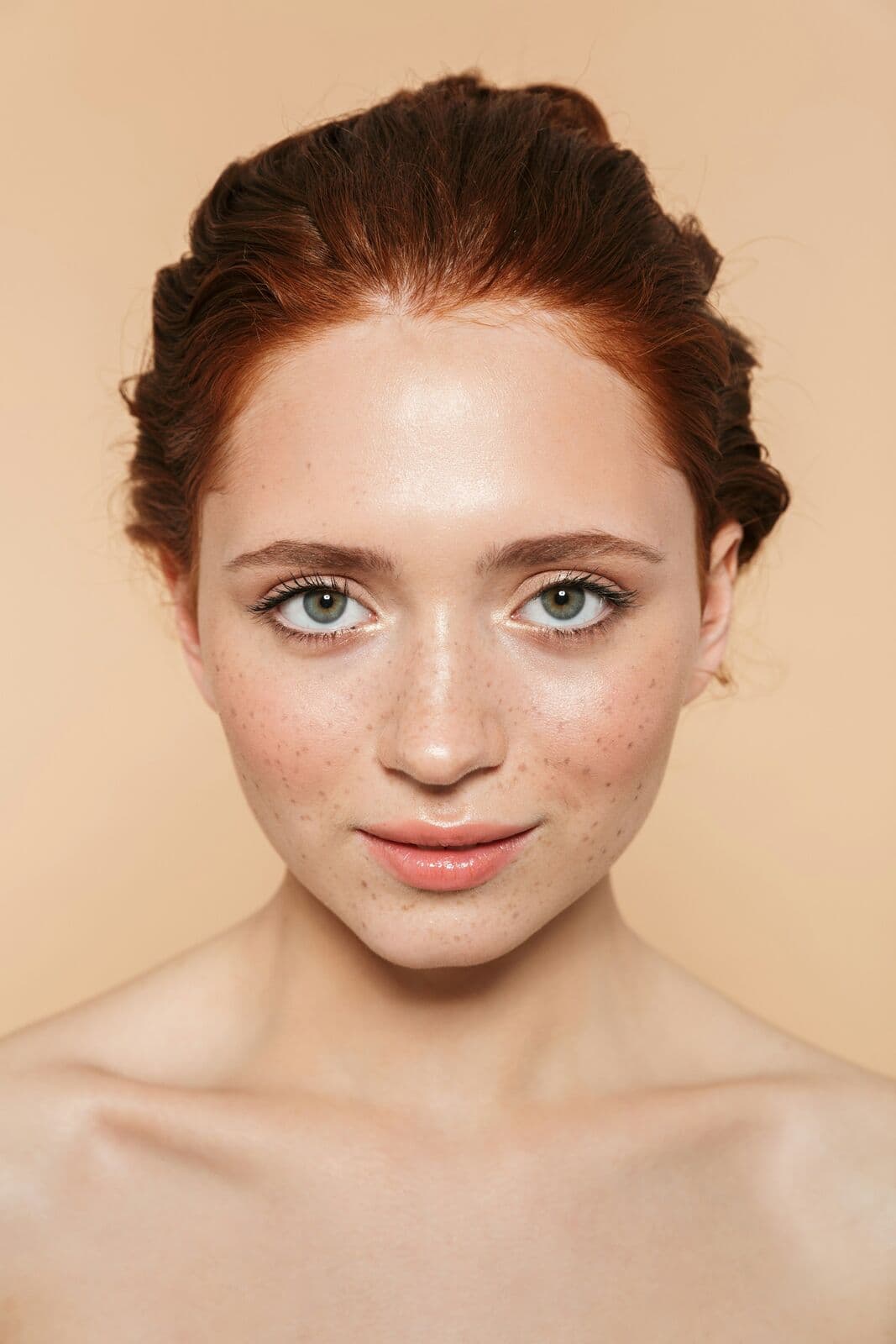 Close portrait of a woman with auburn hair and freckles