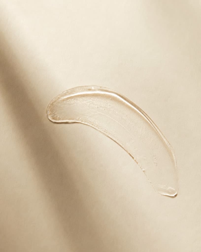 An arc of clear gel spread across paper