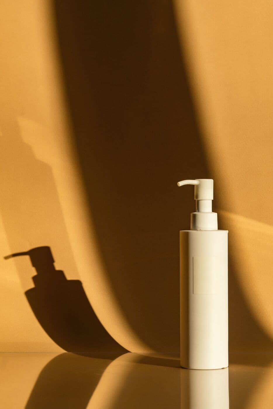 White pump bottle of Daily SPF 40 in strong sunlight